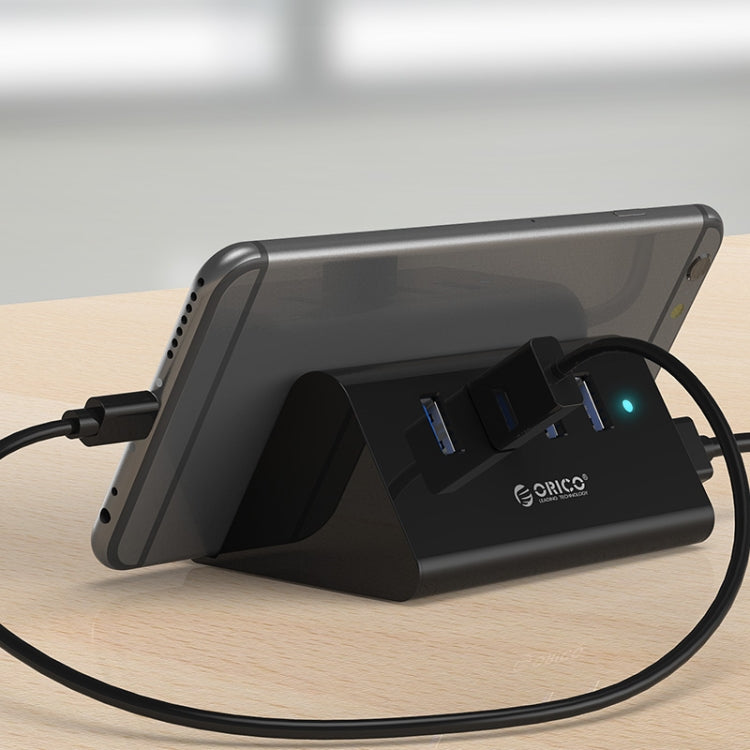 ORICO SHC-U3 วัสดุ ABS เดสก์ท็อป 4 พอร์ต USB 3.0 HUB พร้อมที่วางโทรศัพท์ / แท็บเล็ตและสาย USB 1 ม. และไฟ LED, SHC-U3
